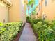 Private brick path lined with lush greenery in a serene and well-maintained community at 3655 Square West Ln # 9, Sarasota, FL 34238