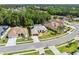 An aerial view of a home featuring well-manicured landscaping, a neutral color palette, and a paved driveway at 4080 Gevalia Dr, Brooksville, FL 34604