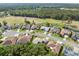 A calm aerial perspective shows houses aligned on quiet roads, complimented by natural streams and golf course views at 4080 Gevalia Dr, Brooksville, FL 34604