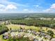 Aerial view of an upscale neighborhood with well-maintained homes and a scenic golf course in the backdrop at 4080 Gevalia Dr, Brooksville, FL 34604