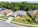 Aerial view of home featuring mature trees, professional landscaping, and inviting curb appeal at 4080 Gevalia Dr, Brooksville, FL 34604