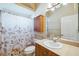 Bathroom with shower/tub combo, wooden vanity, and mirrored medicine cabinet at 4080 Gevalia Dr, Brooksville, FL 34604