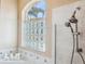 Modern bathroom features a glass block window and a luxurious multi-head shower system at 4080 Gevalia Dr, Brooksville, FL 34604
