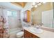 Bathroom features a bathtub/shower combo, and a wooden vanity with a mirrored medicine cabinet at 4080 Gevalia Dr, Brooksville, FL 34604