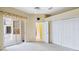Bedroom featuring a sliding glass door, a view to a screened in lanai, and a large closet at 4080 Gevalia Dr, Brooksville, FL 34604