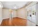 Empty bedroom with wood floors, ceiling fan, neutral walls, and sliding door to the patio at 4080 Gevalia Dr, Brooksville, FL 34604