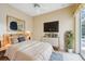 Cozy bedroom featuring a comfortable bed, wall-mounted TV, and access to the pool area at 4080 Gevalia Dr, Brooksville, FL 34604