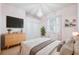 Stylish bedroom featuring a decorative chandelier, TV, large windows, and neutral accents at 4080 Gevalia Dr, Brooksville, FL 34604