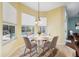 A breakfast nook with yellow walls and a view of the pool through multiple windows at 4080 Gevalia Dr, Brooksville, FL 34604