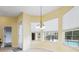 An eat-in kitchen area with tile floors, yellow walls, large windows and views to backyard swimming pool at 4080 Gevalia Dr, Brooksville, FL 34604