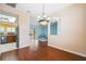 A dining room next to the kitchen, with hardwood floors and a view to the pool area and living room at 4080 Gevalia Dr, Brooksville, FL 34604