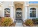 The front entrance features double doors flanked by fluted columns and sidelight windows beneath an arched transom at 4080 Gevalia Dr, Brooksville, FL 34604