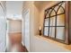 Hallway with hardwood floors, neutral walls, and a decorative mirror at 4080 Gevalia Dr, Brooksville, FL 34604