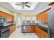 Bright kitchen featuring wooden cabinets, granite countertops, stainless steel appliances, and tile flooring at 4080 Gevalia Dr, Brooksville, FL 34604