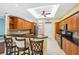 Well-lit kitchen boasts wooden cabinets, tile backsplash, granite counters, and stainless appliances at 4080 Gevalia Dr, Brooksville, FL 34604