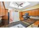 An open kitchen features wood cabinets, dark granite countertops, and a kitchen doorway at 4080 Gevalia Dr, Brooksville, FL 34604
