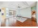 A serene living room featuring tray ceilings, light walls, and wood floors, bathed in natural light from the sliding doors at 4080 Gevalia Dr, Brooksville, FL 34604