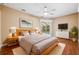 Spacious main bedroom with hardwood floors, ceiling fan, and a sliding door to the pool area at 4080 Gevalia Dr, Brooksville, FL 34604