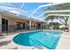 Beautiful pool with a screened-in enclosure and spacious deck, ideal for relaxation and recreation at 4080 Gevalia Dr, Brooksville, FL 34604