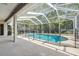 Screened-in pool area with black safety fence and covered patio; perfect for outdoor entertaining at 4080 Gevalia Dr, Brooksville, FL 34604