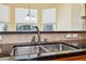 Close-up of a kitchen sink area with stainless steel sink and granite countertops at 4080 Gevalia Dr, Brooksville, FL 34604