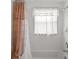 Bathroom with a bathtub and tiled walls, a shower curtain, and a window at 4335 Duval St, Spring Hill, FL 34606