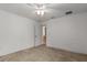 Neutral bedroom featuring a ceiling fan, carpet flooring, and access to the hallway at 4335 Duval St, Spring Hill, FL 34606