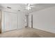 Bedroom featuring tan carpet, ceiling fan, and a closet with double doors at 4335 Duval St, Spring Hill, FL 34606