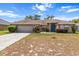 Charming single-story home featuring a well-manicured lawn, attached garage, and inviting blue front door at 4335 Duval St, Spring Hill, FL 34606