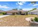 Charming single-story home featuring a lush lawn and front garden with stone accents and mature plantings at 4335 Duval St, Spring Hill, FL 34606