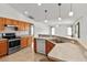 Well-lit kitchen boasts stainless steel appliances, tile flooring, and wooden cabinets at 4335 Duval St, Spring Hill, FL 34606