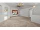 Bright living room features neutral carpet, white walls, high ceilings, and chandeliers for an elegant touch at 4335 Duval St, Spring Hill, FL 34606