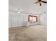 Bright living room features neutral carpet, white walls, high ceilings, and chandeliers for an elegant touch at 4335 Duval St, Spring Hill, FL 34606