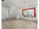 Bright living area with carpet, large window, and overhead chandelier at 4335 Duval St, Spring Hill, FL 34606