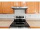 Close-up of a modern black and silver stove with overhead vent at 4335 Duval St, Spring Hill, FL 34606