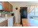 Kitchen featuring tile backsplash, wooden cabinets, and access to outdoor space at 447 Briarwood Ln, Spring Hill, FL 34606