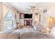 Inviting living room features a fireplace, a ceiling fan, and ample natural light at 447 Briarwood Ln, Spring Hill, FL 34606