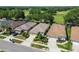 Aerial shot of houses featuring well-maintained lawns and close proximity to lush trees, creating a peaceful neighborhood at 4500 Golf Club Ln, Spring Hill, FL 34609