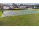 Outdoor basketball court with well-maintained green and blue surface surrounded by lush lawns and upscale homes at 4500 Golf Club Ln, Spring Hill, FL 34609
