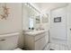 Clean bathroom featuring a single sink vanity, a large mirror, and modern fixtures and decor at 4500 Golf Club Ln, Spring Hill, FL 34609