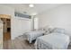 Bedroom showcasing twin beds, white walls and a closet with light grey hardwood floors at 4500 Golf Club Ln, Spring Hill, FL 34609