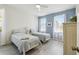 Bright bedroom featuring two beds, neutral walls, and light grey hardwood floors at 4500 Golf Club Ln, Spring Hill, FL 34609