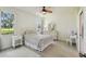 Bright bedroom with ceiling fan, neutral decor, and plenty of natural light at 4500 Golf Club Ln, Spring Hill, FL 34609