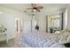 Bedroom features ceiling fan, sliding door to patio, and access to ensuite bathroom at 4500 Golf Club Ln, Spring Hill, FL 34609