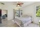 Light-filled bedroom featuring a ceiling fan and access to a patio at 4500 Golf Club Ln, Spring Hill, FL 34609