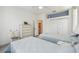 Bright bedroom featuring two twin beds, hardwood floors and a view to the bathroom at 4500 Golf Club Ln, Spring Hill, FL 34609
