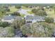 Aerial view of the community clubhouse surrounded by lush greenery, golf course, and ample parking at 4500 Golf Club Ln, Spring Hill, FL 34609