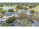 Aerial view of the community clubhouse surrounded by lush greenery, golf course, and parking at 4500 Golf Club Ln, Spring Hill, FL 34609