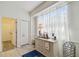 Bright dining area with sheer curtains, built-in cabinet, and stylish decor at 4500 Golf Club Ln, Spring Hill, FL 34609