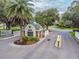 The community guard house at entry with tropical landscaping, providing security and charm at 4500 Golf Club Ln, Spring Hill, FL 34609